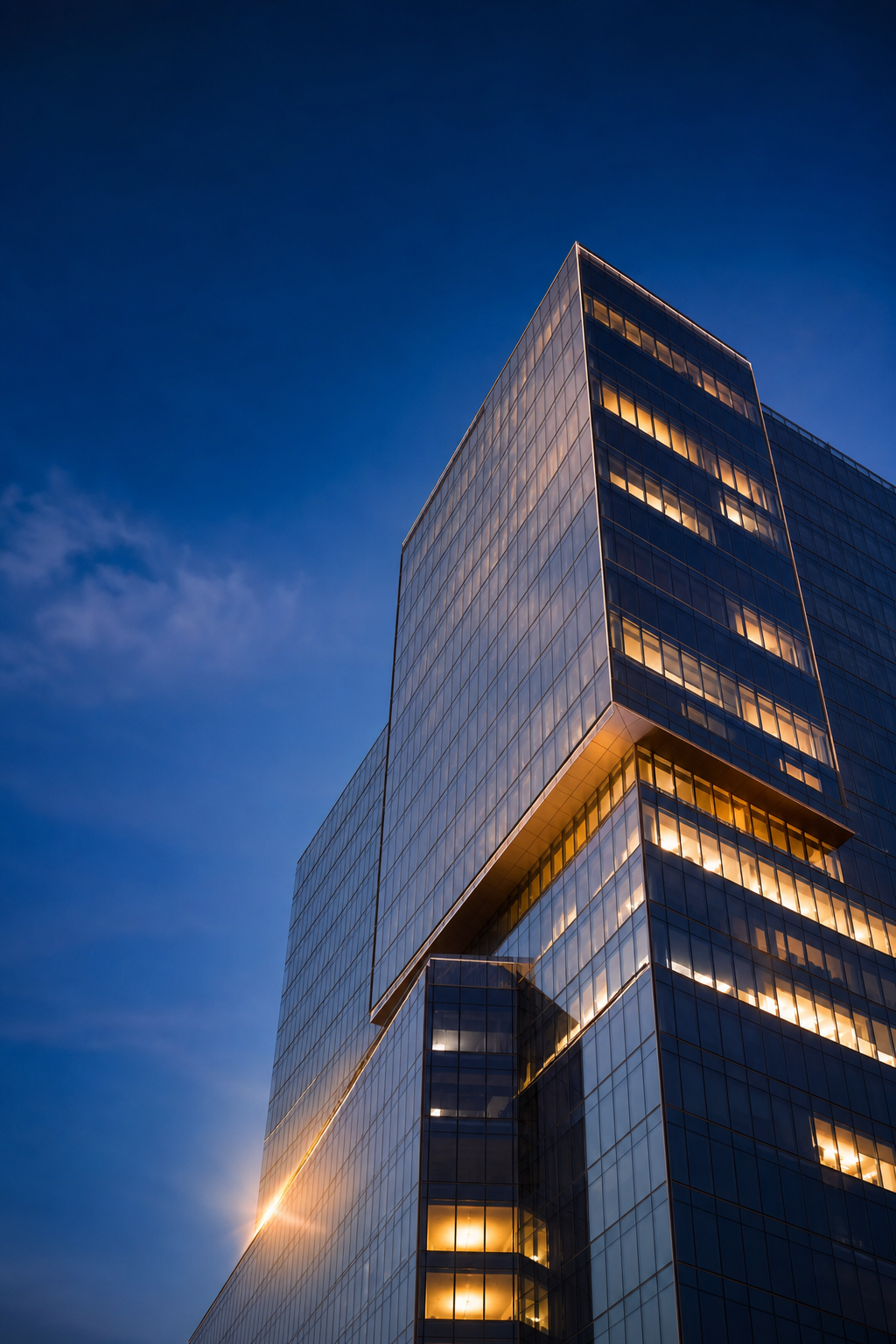 Modern glass office tower at dusk — 4J Insurance Agency, commercial insurance brokerage in Frisco, TX Modern glass office tower at dusk — 4J Insurance Agency, commercial insurance brokerage in Frisco, TX