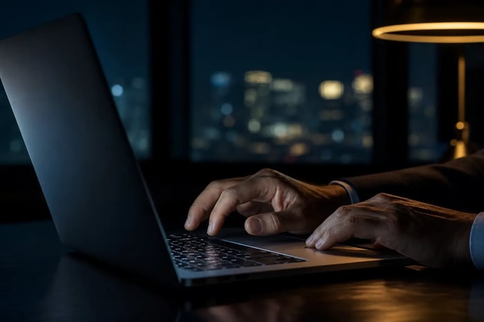Businessmans Hands at Laptop in Dark Office at Night Businessmans Hands at Laptop in Dark Office at Night
